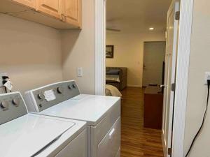a kitchen with a washing machine in a room at Spacious & Pet Friendly Oceanside Home in Oceanside