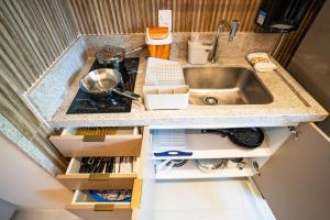 a kitchen counter with a sink and some boxes at Flat Beira Mar Carneiros in Tamandaré +28 photos