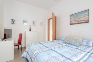 a bedroom with a bed and a desk and a tv at Dimora del Sole 2 - Intero Appartamento in LʼAquila