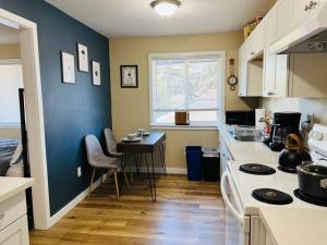 a kitchen with a stove and a table in it at Two side-by-side apartments in Salem