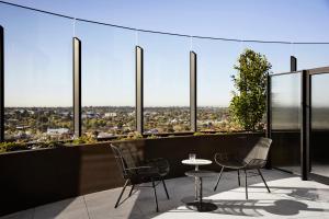vistas desde la parte superior de un edificio con sillas y mesa en Hotel Chadstone Melbourne, MGallery, en Chadstone