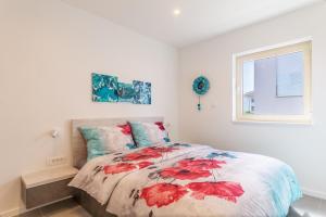 a bedroom with a bed with red leaves on it at Seaside house for families with children Mandre, Pag - 22603 in Kolan