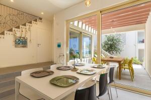 a kitchen and dining room with a table and chairs at Seaside house for families with children Mandre, Pag - 22603 in Kolan +17 photos