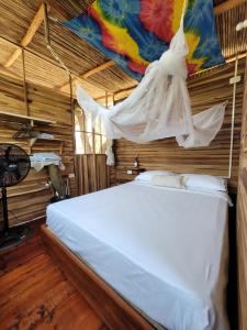 a bedroom with a bed with a mosquito net at Atalaya del Mar Palomino in Palomino