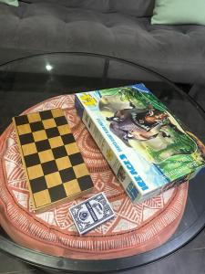 two books and a chess board on a glass table at 1 Bedroom apartment With Hot Tub in cardiff in Cardiff
