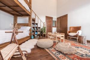 a bedroom with a bed and a chair and a table at Munduk Mountain Estate in Munduk