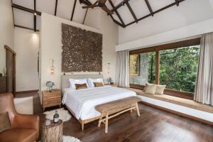 a bedroom with a bed and a large window at Munduk Mountain Estate in Munduk +22 photos