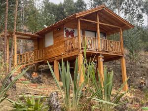 a large wooden house with a butterfly on it at Cabaña Monarca in Paipa
