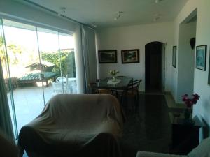 sala de estar con mesa y comedor en Confortável, 1min da praia a pé en Niterói