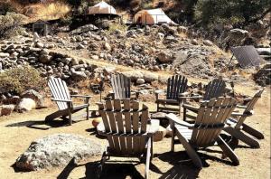 a group of chairs sitting in the dirt at Paradise Ranch Inn - Lucky Tent in Three Rivers