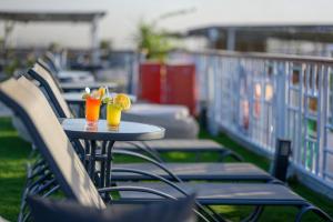 a table with two glasses of orange juice on it at Nile Cruise luxury boat Every Saturday From Luxor & Every Wednesday from Aswoan in Aḑ Ḑab‘īyah