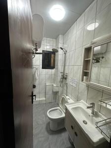 a bathroom with a toilet and a sink at B&B apartments in Yaoundé