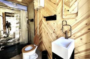 a bathroom with a toilet and a sink at Paradise Ranch Inn - Liberated Tent in Three Rivers