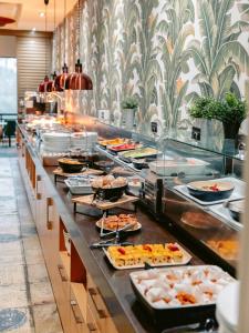 a buffet line with many plates of food at Mercure Gold Coast Resort in Gold Coast