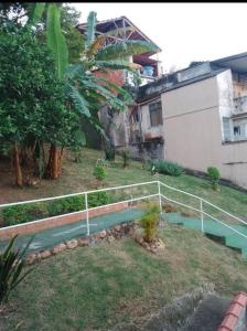 um jardim com uma cerca ao lado de um edifício em Casa Grande e Confortável no Rio de Janeiro
