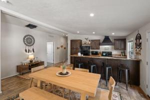 a kitchen and dining room with a wooden table at Dreamcatcher in West Yellowstone