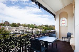 a balcony with a table and chairs and a view at Spacious Studio With Balcony in Inner-City Glebe in Sydney