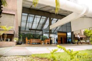 a person walking in front of a building at Harmonia Flat's - Aeroporto Gru in Guarulhos