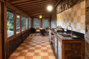 an open kitchen with a dining room with a table at Bali Bohemia Huts in Ubud