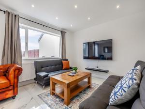 a living room with a couch and a table at Uk46915 - 2 Orchard Farm Cottage in East Grinstead