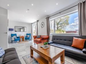 a living room with a couch and a table at Uk46915 - 2 Orchard Farm Cottage in East Grinstead