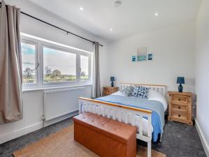 a bedroom with a bed and a window at Uk46915 - 2 Orchard Farm Cottage in East Grinstead
