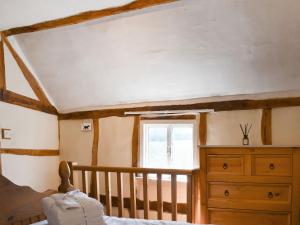 a room with a bed and a dresser and a window at Cobblers Retreat in Birley