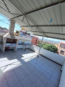 a balcony with a table and a view of a city at Departamentos San Luis in Tarija