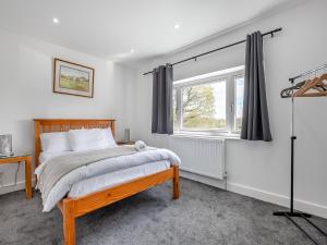a bedroom with a bed and a window at Uk46877 - 1 Orchard Farm Cottage in East Grinstead