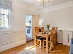 a kitchen and dining room with a table and chairs at Forsythia House in Overstrand
