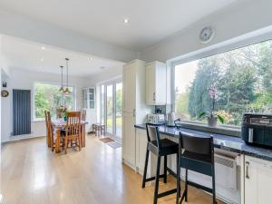 a kitchen and dining room with a table and chairs at Forest View Cottage in Nottingham