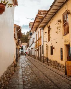 una antigua calle adoquinada en una ciudad con edificios en Nature Home Cusco, en Cusco