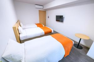 Postel nebo postele na pokoji v ubytování Hotel Sobial Namba Daikokucho