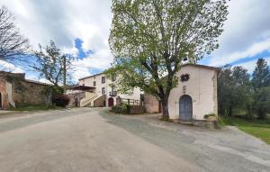 an empty road in front of a white house at Awesome Home In Faugres With Private Swimming Pool, Can Be Inside Or Outside in Faugères