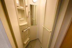 a small bathroom with a toilet and a mirror at Hotel Sobial Namba Daikokucho in Osaka