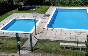 a large swimming pool sitting on top of a yard at Awesome Apartment In Germignaga va With Outdoor Swimming Pool in Germignaga