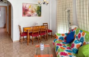 a living room with a table and a couch at 1 Bedroom Pet Friendly Apartment In San Javier in San Javier