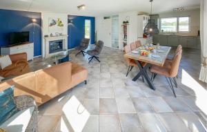 a living room with a table and a couch at 3 Bedroom Beautiful Home In Makkum in Makkum