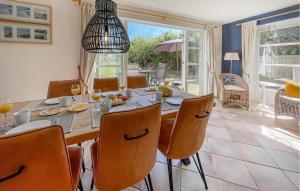 a dining room with a large table and chairs at 3 Bedroom Beautiful Home In Makkum in Makkum