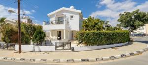 a white house on the corner of a street at Ferienhaus mit Privatpool für 6 Personen ca 180 qm in Agia Napa, Südküste von Zypern in Ayia Napa