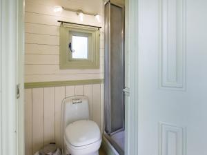 een kleine badkamer met een toilet en een raam bij The Hideaway in Quatford