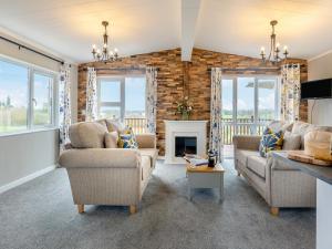 a living room with two couches and a fireplace at Winnal View - Uk46891 in Kinlet