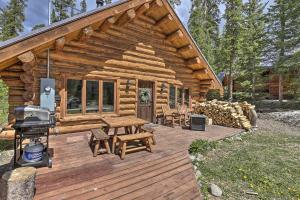 a log cabin with a picnic table and a grill at Cozy Breckenridge Cabin with Deck, 8 Mi to Gondola in Breckenridge
