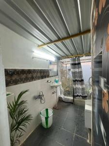 a bathroom with a tub and a sink and a toilet at Hide away valley in Kodaikānāl