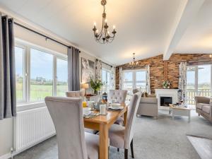 a dining room and living room with a table and chairs at Church View - Uk46896 in Kinlet