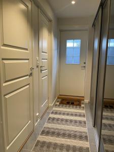 a hallway with a door and a tile floor at Home for your trip in Klofta