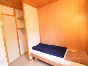 a small bedroom with a bed and a closet at Gîte Salers, 3 pièces, 4 personnes - FR-1-742-439 in Salers