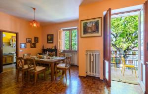 a dining room with a table and chairs and a balcony at Amazing Apartment In Montefelcino in Montefelcino