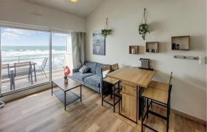 a living room with a couch and a table at Nice Apartment In Les Sables-D'olonne in Les Sables-dʼOlonne