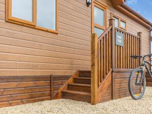 a bike parked next to a building with stairs at Park View - Uk46898 in Kinlet